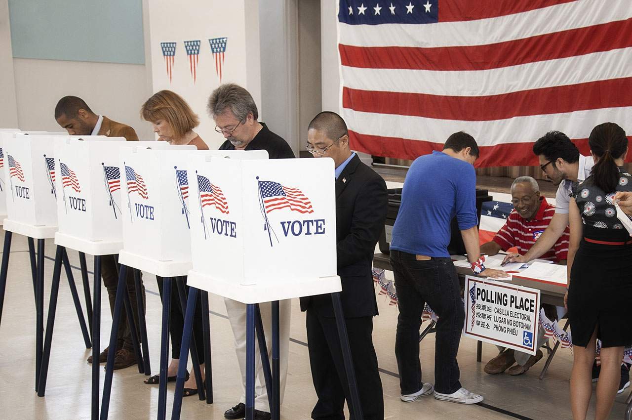 Americans of diverse backgrounds voting, reflecting civic participation as a form of preserving freedom