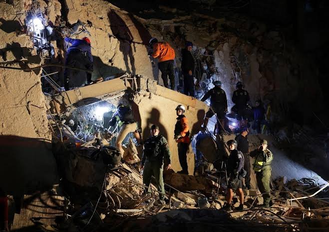 Volunteers and rescuers search rubble in Caracas Venezuela earthquake June 2026